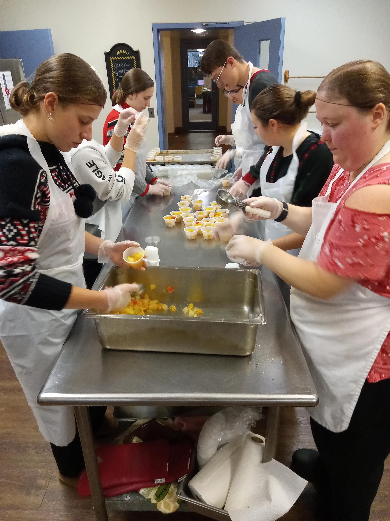 Government interns packaging fruit cups for Senior citizens