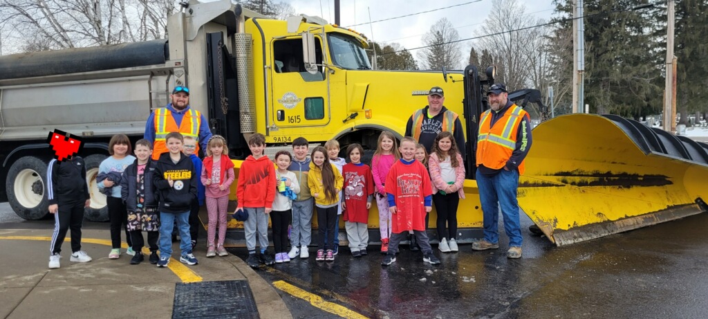 Students with Cattaraugus County employees in front of truck